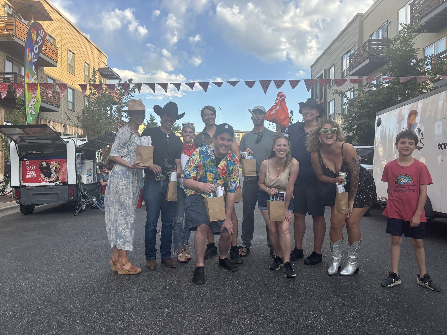 Group photo with cowboy hats and gift bags